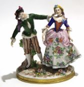 Late 19th century/20th century Continental porcelain model of a boy and girl on a flower encrusted