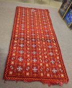 Good quality modern carpet predominantly in red, orange and cream with repeating geometric lozenge