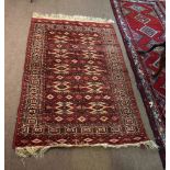 Good quality Bokhara carpet decorated predominantly in cream, red and brown with geometric repeating