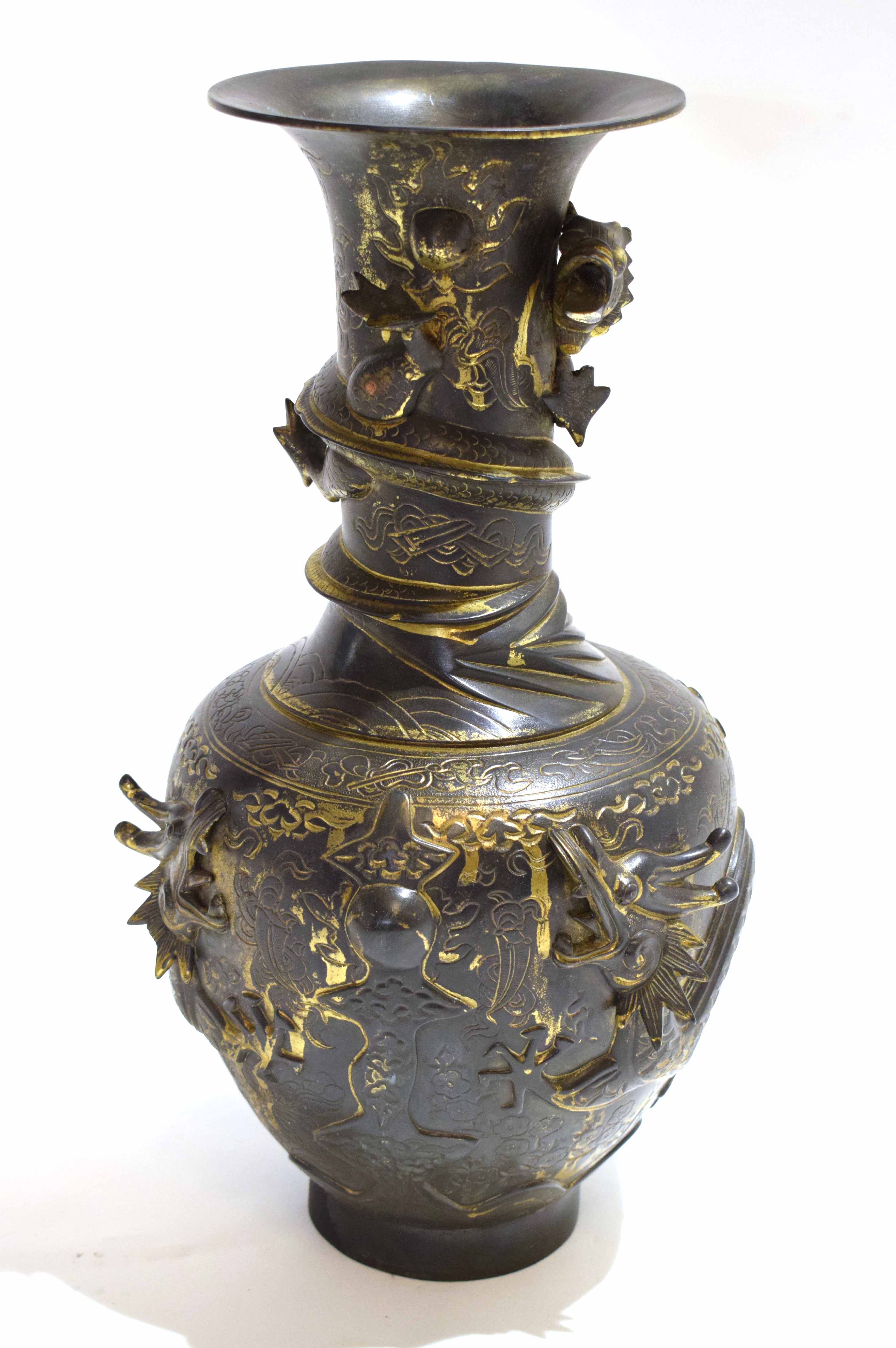 Chinese bronze vase with tapered neck, the body with applied decoration of a sinuous dragon