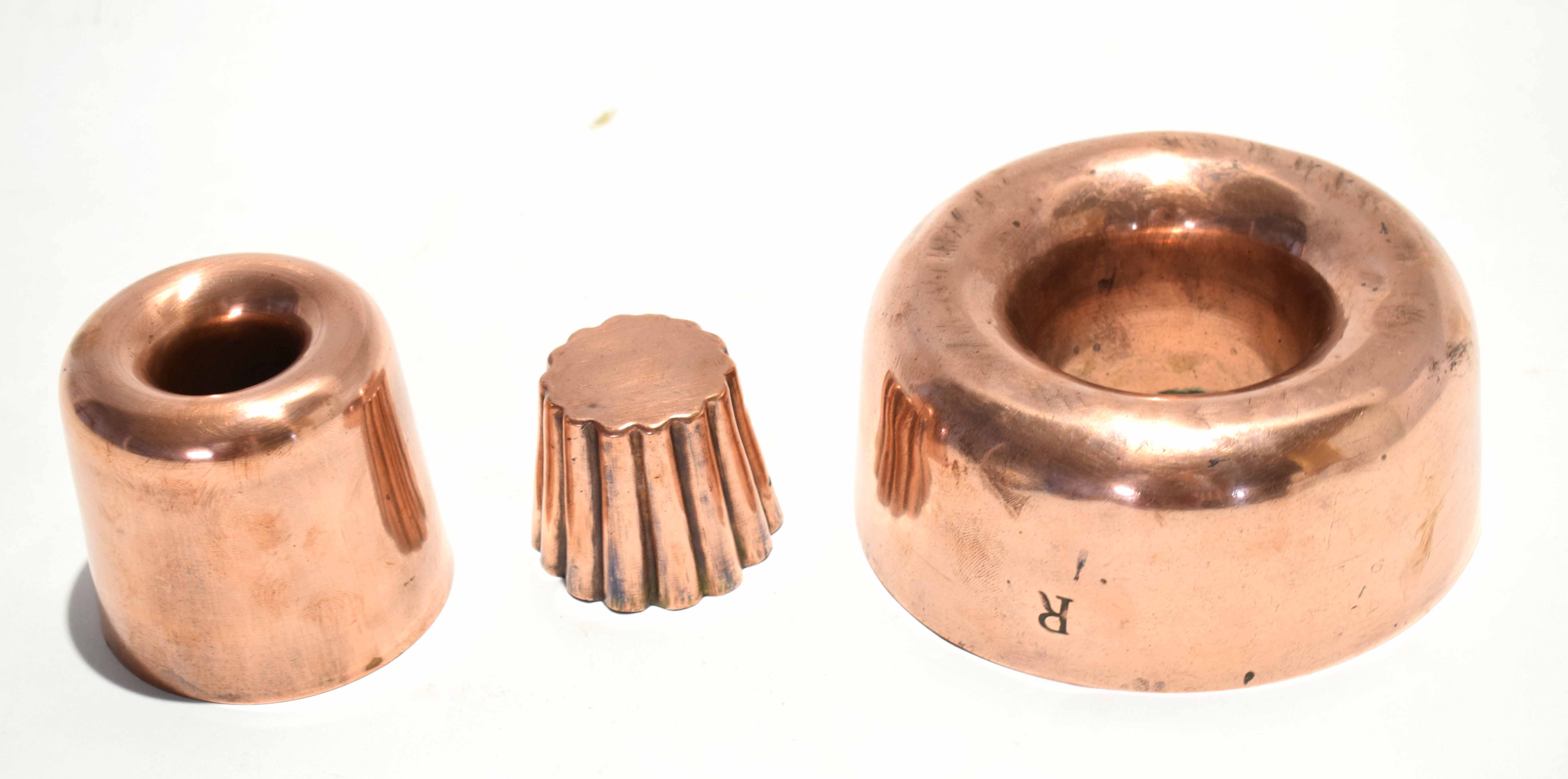 Three 19th century copper jelly moulds, one of circular form with void centre, the other formed as a