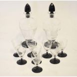 Pair of decanters engraved with a boat and island pattern with tear drop faceted stoppers,
