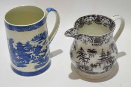 Large Pearlware cylindrical mug with a blue and white design, together with a further jug with a