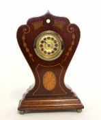 Art Nouveau style clock with inlay to the front, the clock mounted on four small ball feet