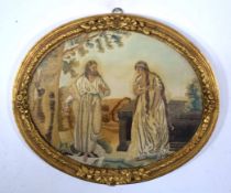 Gilt panel containing silk work of two religious figures, 40cm long