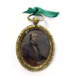 Pinchbeck framed small daguerrotype pendant of a young man, 3 x 2cm