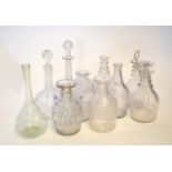 Group of ten cut glass decanters, some lacking stoppers, with typical cut glass designs, one with