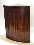 18th century inlaid oak bow fronted wall mounting corner cabinet with panelled doors and fitted