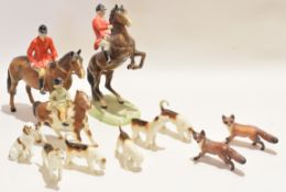 Group of Beswick models of huntsmen, one on a rearing horse, together with a pack of hounds and