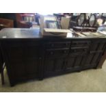 GOOD QUALITY LARGE ERCOL DRESSER FITTED CENTRALLY WITH FOUR DRAWERS OVER TWO CUPBOARD DOORS