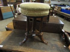 EDWARDIAN WALNUT CARVED REVOLVING PIANO STOOL ON THREE COLUMNS ON A SPLAYED BASE