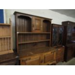 ARTS & CRAFTS DRESSER, THE TOP FITTED WITH SINGLE CUPBOARD DOOR WITH TWO OPEN SHELVES, THE BASE