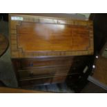 TEAK FRAMED DROP FRONTED BUREAU WITH THREE FULL WIDTH DRAWERS WITH RINGLET HANDLES RAISED ON PAD