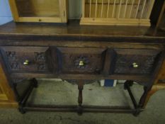 OAK FRAMED SIDEBOARD WITH THREE DRAWERS WITH CARVED DETAIL ON TURNED LEGS WITH BRASS KNOB HANDLES