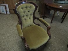 19TH CENTURY WALNUT FRAMED ARMCHAIR WITH CARVED TOP AND SHAPED ARMS WITH GREEN DRALON UPHOLSTERY AND