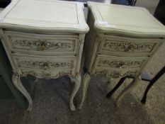 PAIR OF WHITE PAINTED TWO DRAWER BEDSIDE TABLES WITH CARVED DRAWER FRONTS ON CABRIOLE LEGS (2)