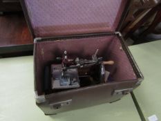 BROWN REXINE CASED CHILD'S SEWING MACHINE