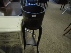 OAK FORMED BARREL TYPE PLANT STAND WITH BRASS BANDING SUPPORTED ON THREE LEGS WITH A TRIANGULAR