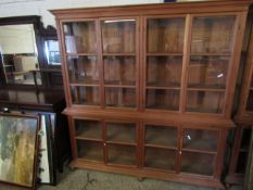 BEECH WOOD SHOP DISPLAY CABINET FITTED WITH EIGHT GLAZED SECTIONAL DOORS RAISED ON BUN FEET