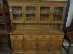 GOOD QUALITY WAXED PINE DRESSER, THE TOP FITTED WITH FOUR GLAZED DOORS, THE BASE WITH FOUR DRAWERS