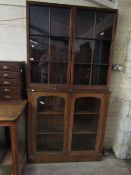 PINE FRAMED BOOKCASE CABINET WITH TWO GLAZED SECTIONAL DOORS AND TWO FITTED SHELVES TO TOP WITH