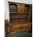 ARTS & CRAFTS DRESSER, THE TOP FITTED WITH SINGLE CUPBOARD DOOR WITH TWO OPEN SHELVES, THE BASE