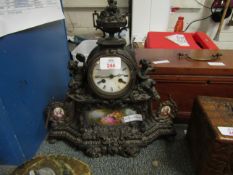 FRENCH GILT METAL MANTEL CLOCK WITH MOUNTED CHERUBS, CAST DECORATIONS AND PORCELAIN PANELS