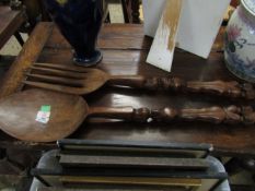 PAIR OF EASTERN SOFTWOOD OVER-SIZED SPOON AND FORK WITH CARVED FIGURAL HANDLES, 97CM LONG