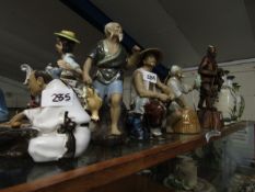 GROUP OF ORIENTAL POTTERY FIGURES MODELLED AS FISHERMEN IN VARIOUS POSES, THE TALLEST 22CM HIGH (4)