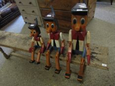 PAINTED ARTICULATED GRADUATED SET OF THREE PINOCCHIO FIGURES