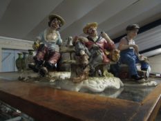 THREE CAPO DI MONTE FIGURES OF A TRAMP ON A BENCH, A COBBLER ETC (3)