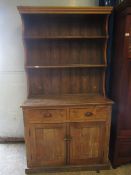 VICTORIAN WAXED PINE DRESSER, THE TOP FITTED WITH TWO FIXED SHELVES AND PANELLED BACK, THE BASE WITH