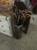 PRESSED BRASS STICK STAND WITH A QUANTITY OF MIXED WALKING STICKS TO INCLUDE TREEN STICKS, SILVER