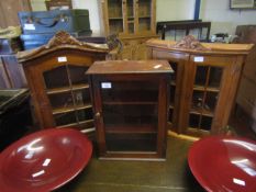 THREE TABLE TOP CABINETS, TWO WITH CARVED PEDIMENTS AND SECTIONALISED DOORS, ONE WITH MAHOGANY FRAME