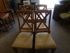 SET OF FOUR BEECHWOOD X FRAME BACK DINING CHAIRS WITH BEIGE UPHOLSTERED SEATS ON TAPERING SQUARE