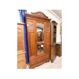 EARLY 20TH CENTURY MAHOGANY MIRROR FRONTED WARDROBE WITH CARVED PEDIMENT AND INSET ART NOUVEAU PRESS