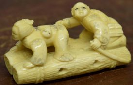 Early 20th century ivory Inro modelled as two figures on a log type canoe, 6cm long