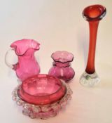 Group of cranberry coloured glass, one with a label for Swedish Art Glass, comprising vase, ewer and