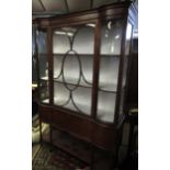 Edwardian mahogany china display cabinet, glazed top with fitted shelving over a fall front door