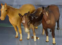 Group of two Beswick porcelain models of horses and a further Beswick donkey (leg a/f), the horse