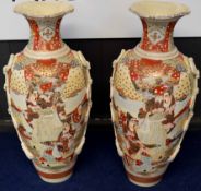 Two large Satsuma earthenware vases decorated in typical fashion with Japanese warriors and