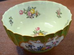 Large fluted Rockingham style bowl, the green ground with gilded panels of flowers in baskets, the