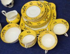 Part Tuscan china tea set, the yellow borders with floral decoration, comprising a sandwich plate