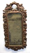 Unusual Black Forest or Bavarian oak wall mirror, the frame intricately carved with berries and