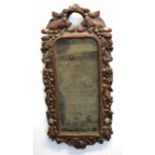 Unusual Black Forest or Bavarian oak wall mirror, the frame intricately carved with berries and