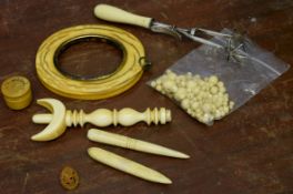 Group of ivory wares including a photo frame and collection of ivory beads and a pair of sugar tongs