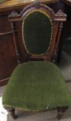 Victorian nursing chair, green upholstered back and seat, arched top with carved detail, flanked