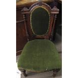 Victorian nursing chair, green upholstered back and seat, arched top with carved detail, flanked