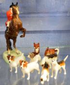Beswick model of a huntsman seated on a rearing horse on a green base, together with three Beswick