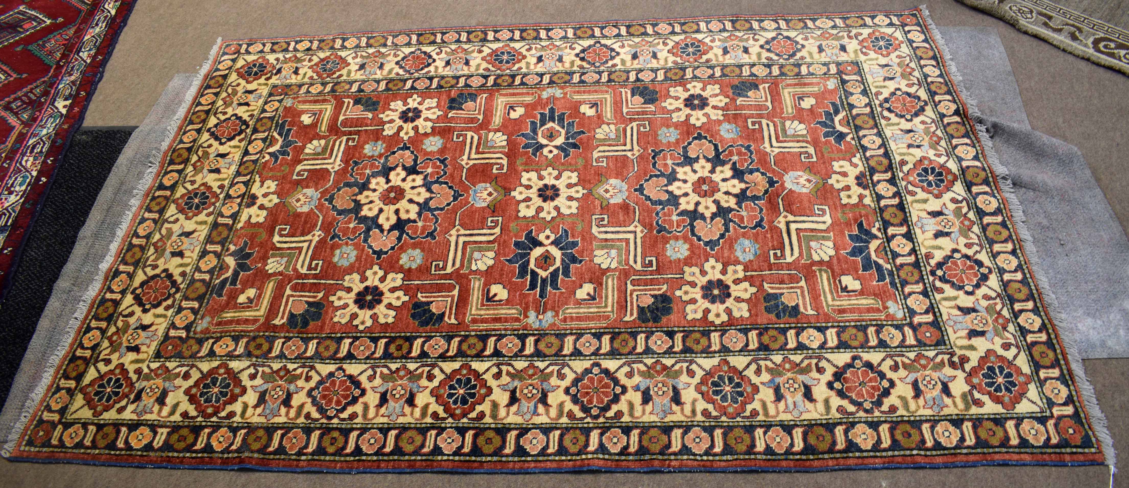 Modern Caucasian style carpet, central panel of geometric lozenges, foliage etc, mainly rust